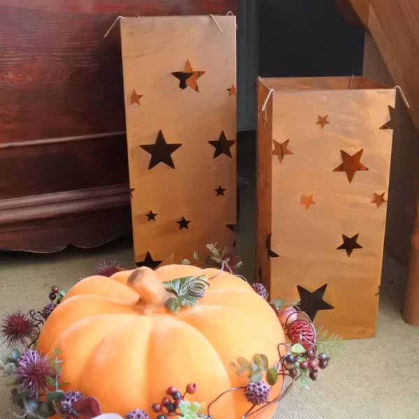 Dekorative Herbstszene mit Kürbis und Laternen mit Sternausschnitten
