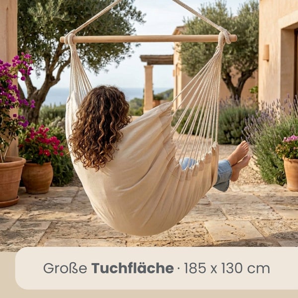 Hängesessel aus hellem Stoff mit Holzquerstab auf einer mediterranen Terrasse, Tuchfläche 185 mal 130 Zentimeter.