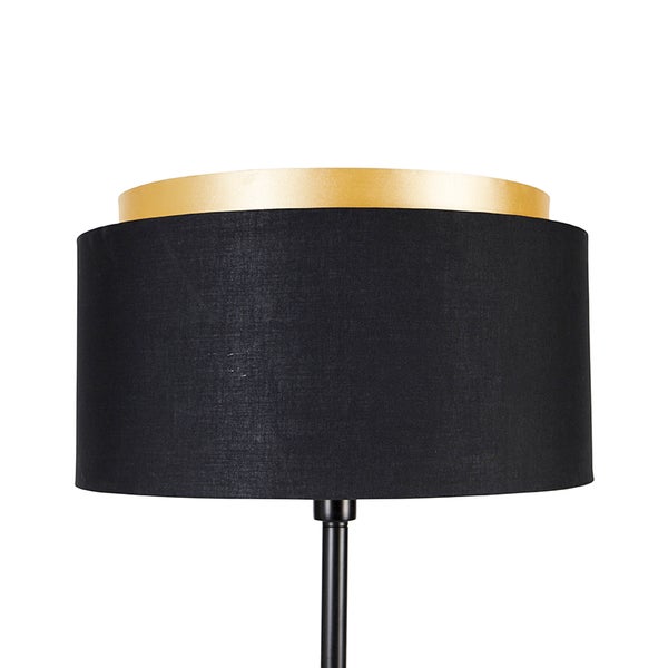 Stehleuchte mit schwarzem Schirm und goldfarbenem Akzent