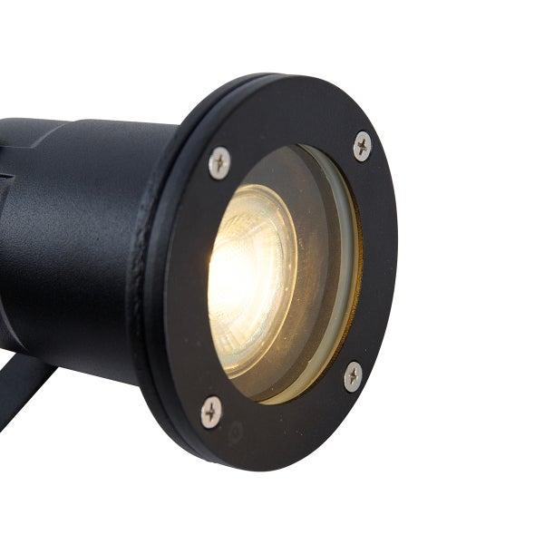 Schwarzer Außenstrahler mit rundem Kopf, Glasscheibe und vier Schrauben, der warmes Licht abgibt.
