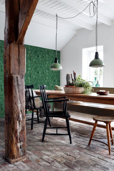 Esszimmer mit Holztisch, Stühlen, grüner Blättertapete und Pendelleuchten