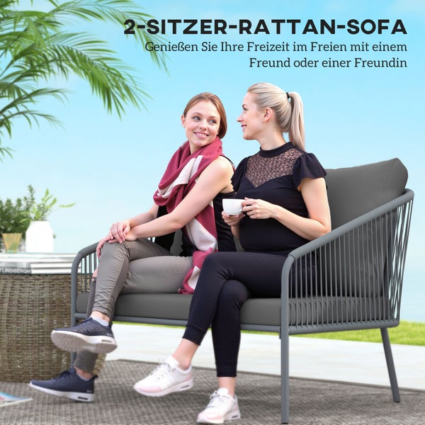 Zwei Personen sitzen auf einem grauen 2-Sitzer-Rattan-Sofa in einer hellen Gartenumgebung mit Metallgestell und Polstern.