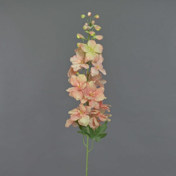 Künstlicher Blumenzweig mit rosa Blüten und grünen Blättern.