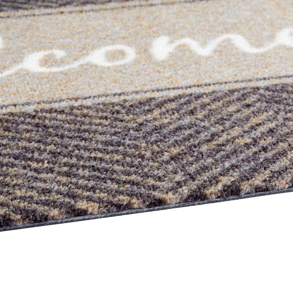 Detailansicht einer Fußmatte mit dem Schriftzug Willkommen.