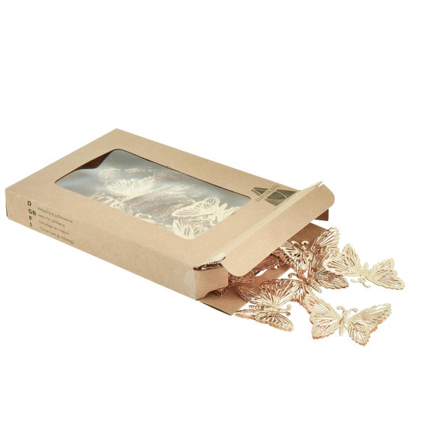 Dekorative goldfarbene Schmetterlinge in einer Pappschachtel