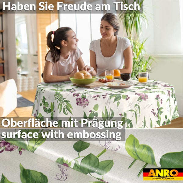 Runde Tischdecke mit geprägter Oberfläche, Blumenmuster mit Blättern und Blüten. Mutter und Kind an einem gedeckten Tisch. ANRO Logo.