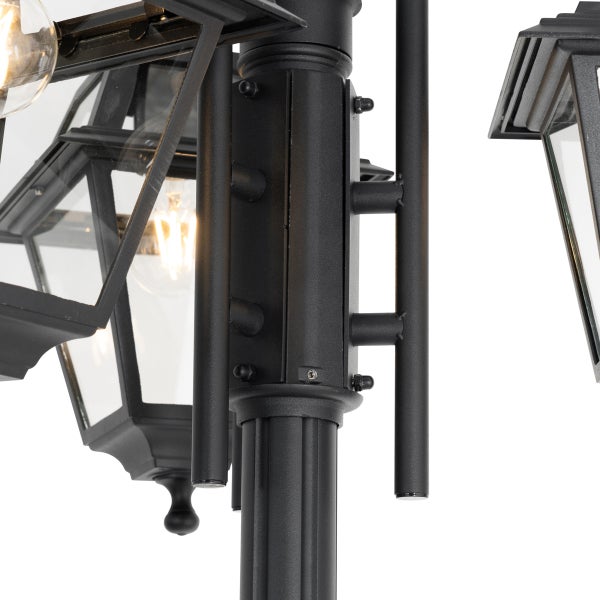 Detailaufnahme einer klassischen Gartenlaterne aus schwarzem Metall mit Glaseinsätzen.