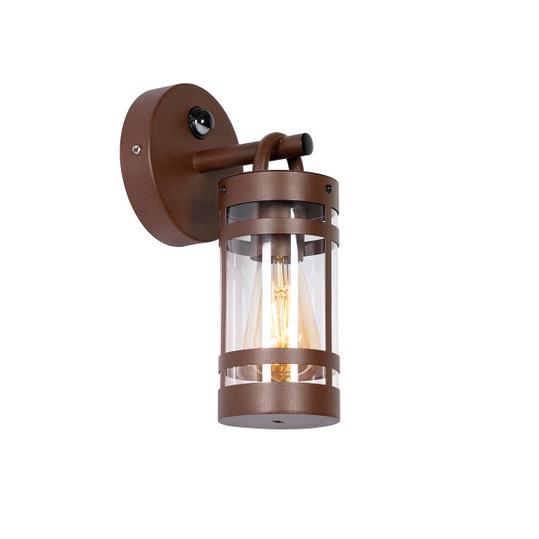 Rustikale Außenwandleuchte in Rostoptik mit Bewegungsmelder, klarem Glaszylinder und sichtbarem Filament-Leuchtmittel.