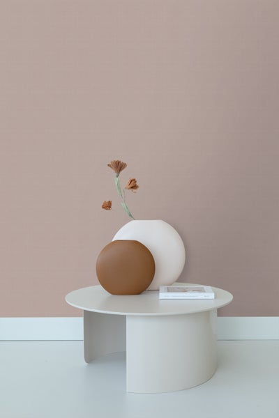 Dekorative Vasen und Tisch mit Buch auf hellem Hintergrund