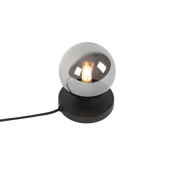 Tischleuchte mit runder, leicht getönter Glasabdeckung auf schwarzem Sockel