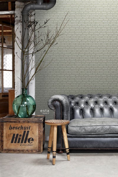 Wohnszene mit Sofa, Hocker, Dekoration und einer Holzkiste