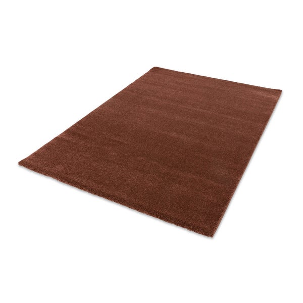 Rechteckiger Hochflor-Teppich in Braun mit weicher Oberfläche.