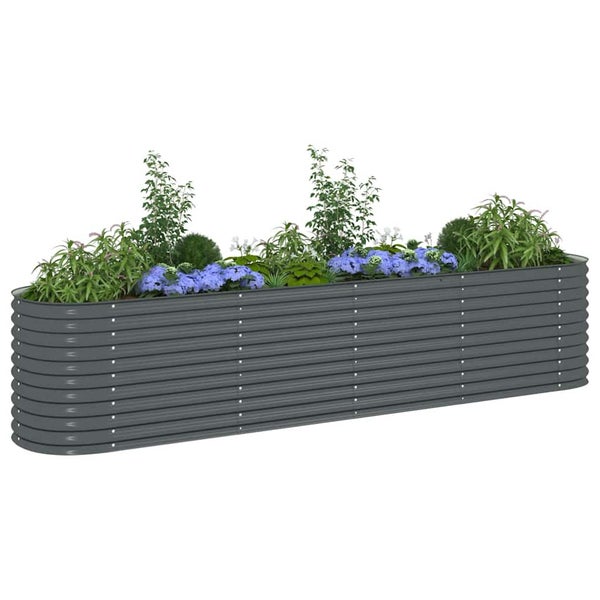 Ovales Hochbeet aus Wellstahl, bepflanzt mit verschiedenen Blumen und Grünpflanzen.