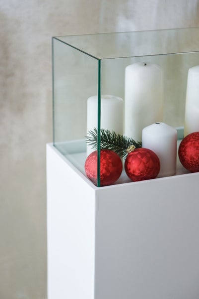 Detailansicht einer Glasvitrine mit weißem Sockel