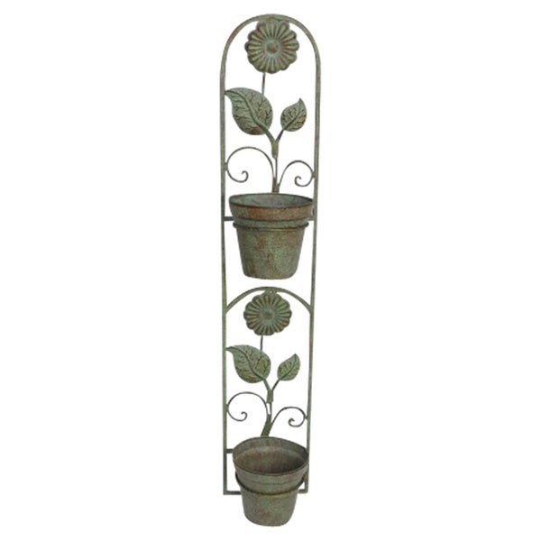 Dekorative Pflanzenwand mit zwei Blumentöpfen und Blumenverzierungen