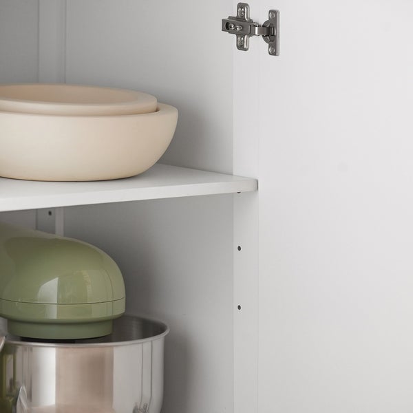 Innenansicht eines Küchenschranks mit Schüsseln und Küchenmaschine