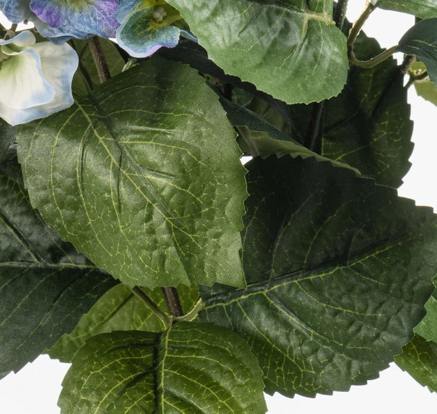 Künstliche Margerite mit weißen Blüten, brauner Mitte, grünen Stielen und Blättern.