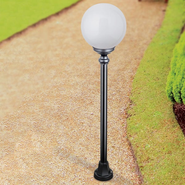 Außenleuchte mit weißer Kunststoffkugel und schwarzem Metallmast an einem Gartenweg aus Kies neben einem Rasen.