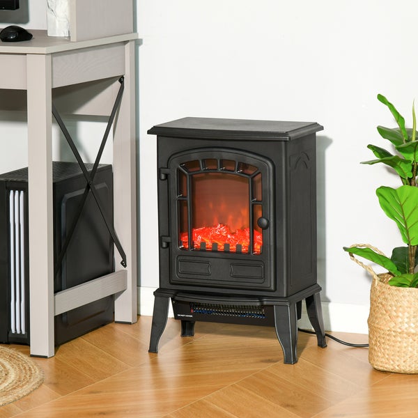 Dekorativer Elektrokamin mit simulierter Flamme neben einem Schreibtisch und einer Zimmerpflanze