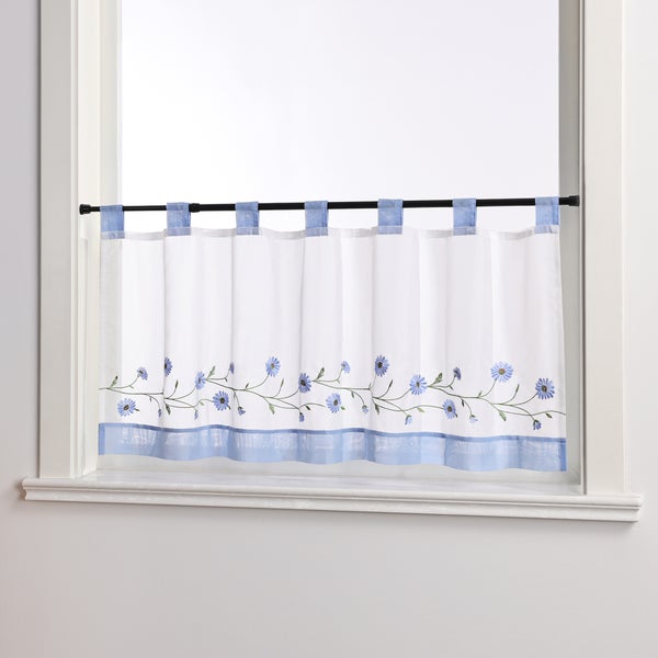 Gardinenstores mit Blumenmuster am Fenster