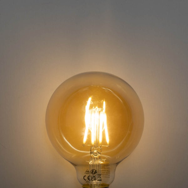 Leuchtendes LED-Leuchtmittel in Globe-Form mit sichtbaren Filamenten und bernsteinfarbenem Glas.