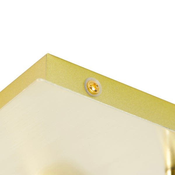 Detailaufnahme einer goldenen Rahmenkante mit Befestigungsschraube