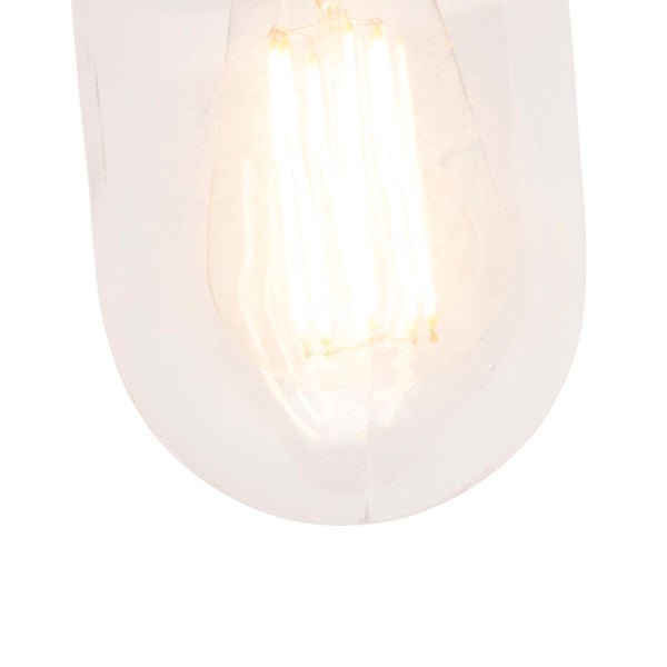 Nahaufnahme einer klaren Glaslampe, die ein warmes Licht ausstrahlt