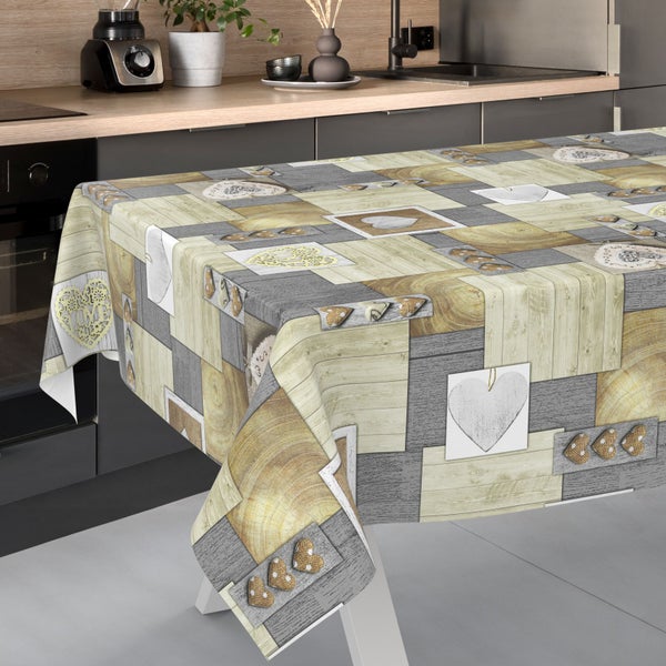 Wachstuch-Tischdecke mit Patchwork-Muster aus Holzoptik und Herz-Motiven in einer modernen Küche.