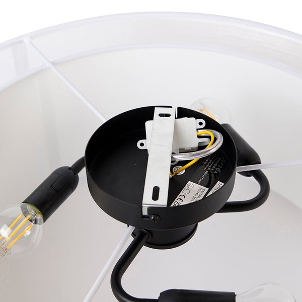 Detailansicht der Deckenbefestigung einer Lampe mit Montagebügel, Anschlussklemme, Kabeln und Leuchtmitteln im Lampenschirm.