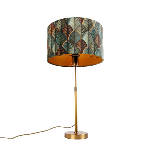 Tischleuchte mit gemustertem Lampenschirm in Blätteroptik und goldenem Metallfuß.