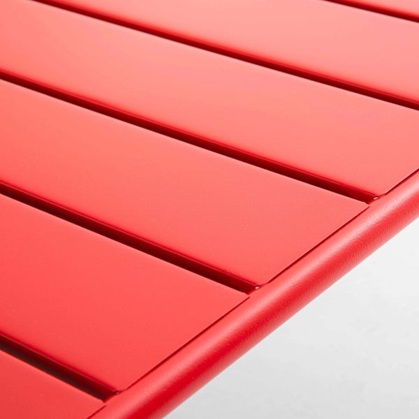 Nahaufnahme einer roten Tischoberfläche mit Metall-Latten und abgerundetem Rahmen.