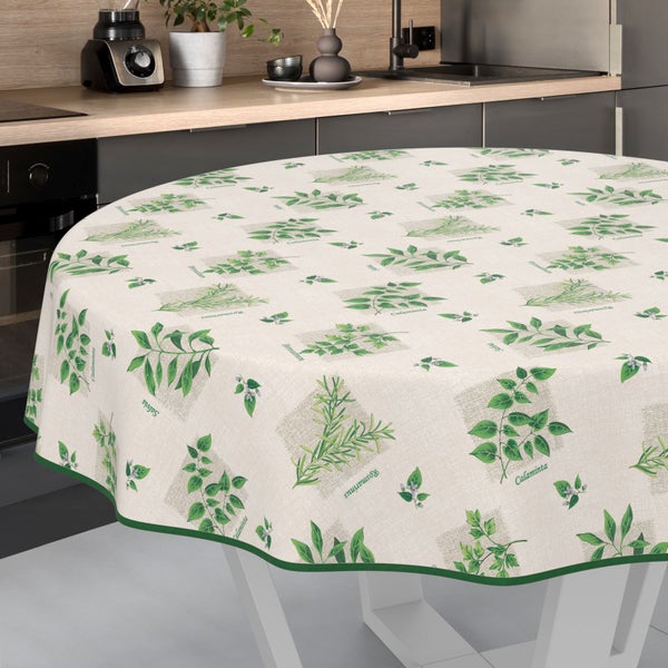 Runde Küchentischdecke mit Kräutermuster auf einem Küchentisch.