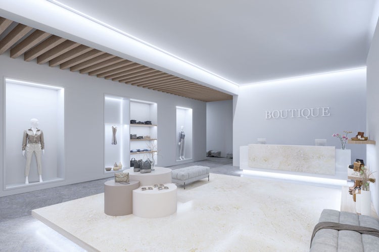 Moderner Boutique-Innenraum mit indirekter Beleuchtung, Holzlamellendecke, Steintheken, Verkaufsnischen mit Mannequins und zentralen Präsentationsflächen.