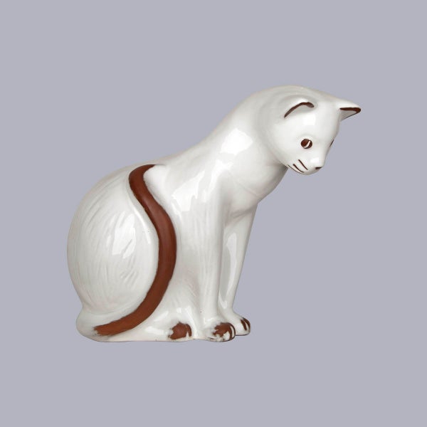 Dekorationsfigur Katze aus Keramik, sitzend, weiß mit braunen Details, glänzend.