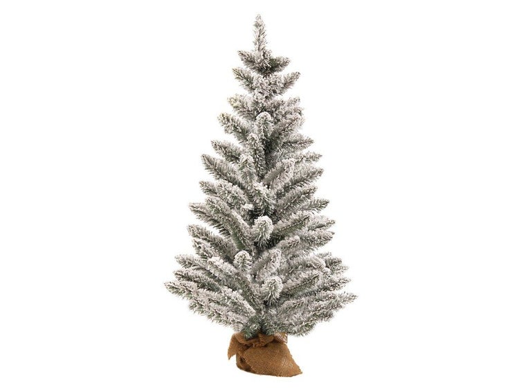 Künstlicher Weihnachtsbaum mit Kunstschnee auf den Nadeln, in einem Jutesack stehend.
