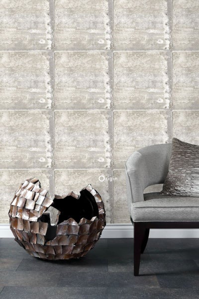 Wohnszene mit Tapete in Betonoptik, dekorativer Kugel und Sessel