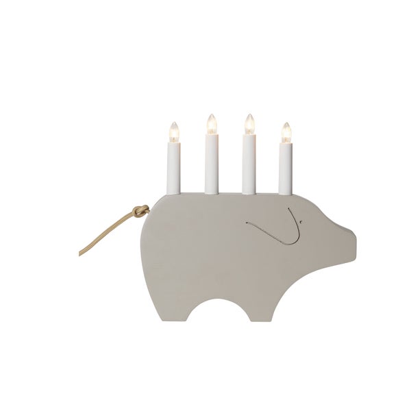 Dekorative Schweine-Lichterbögen aus Holz mit Kerzen auf einem Tisch