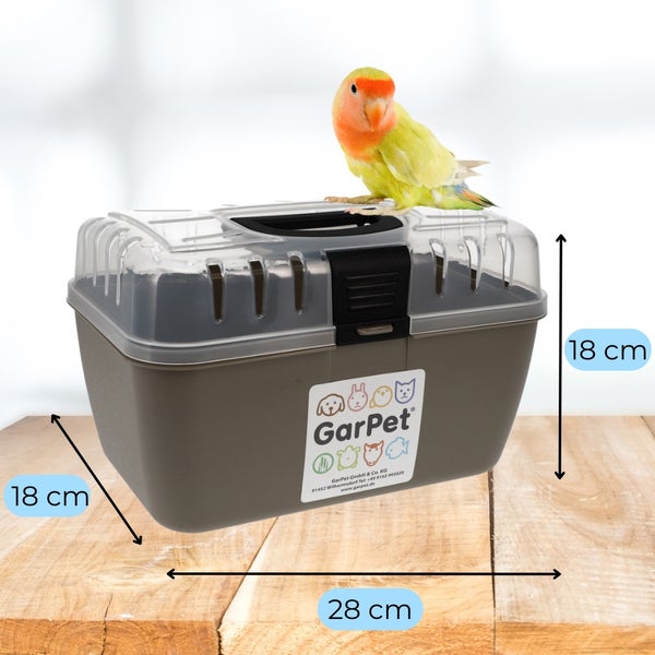 Haustiertransportbox mit den Maßen 18 x 18 x 28 cm und einem Vogel obenauf