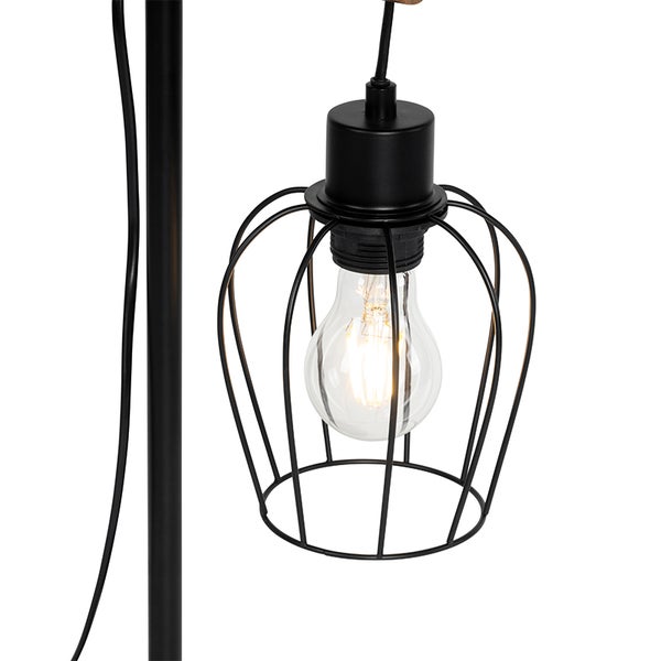 Detailaufnahme einer Lampe mit Lampenfassung und Leuchtmittel in einem schwarzen Drahtkäfig