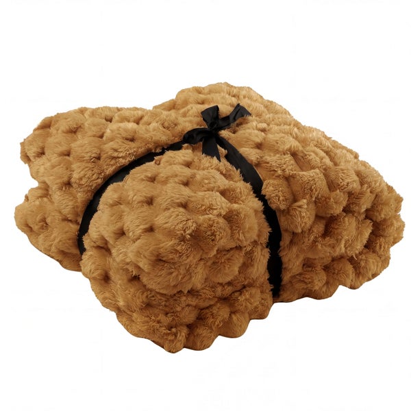 Gefaltete braune strukturierte Plüschdecke mit einer schwarzen Schleife.