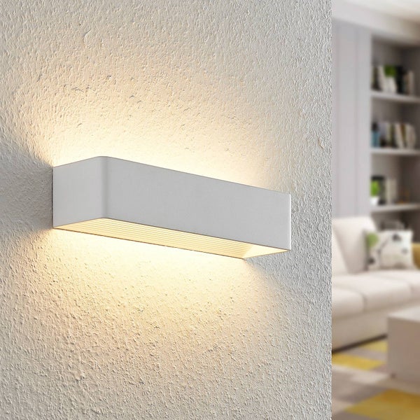 Moderne LED Wandleuchte in rechteckiger Form mit Licht nach oben und unten an einer strukturierten Wand im hellen Wohnzimmer.