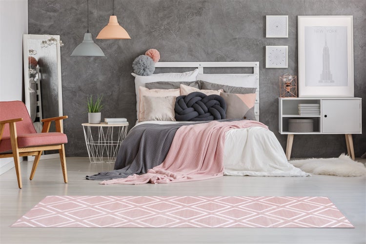 Modernes Schlafzimmer mit einem hellen Teppich mit geometrischem Rautenmuster, kombiniert mit einem Bett und minimalistischer Einrichtung.