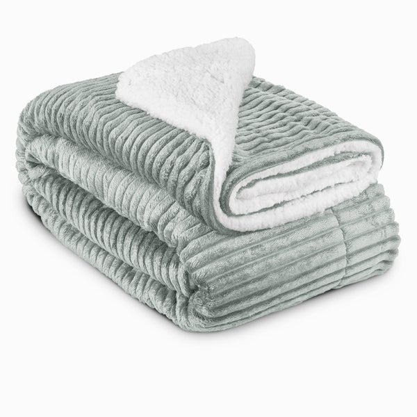 Zusammengelegte Kuscheldecke mit gerippter Oberseite und weicher Unterseite aus synthetischem Material für Wohnzimmer und Schlafzimmer