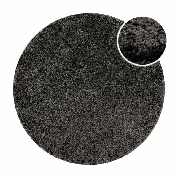Runder, dunkelgrauer Hochflorteppich mit Detailansicht der weichen Faserstruktur.