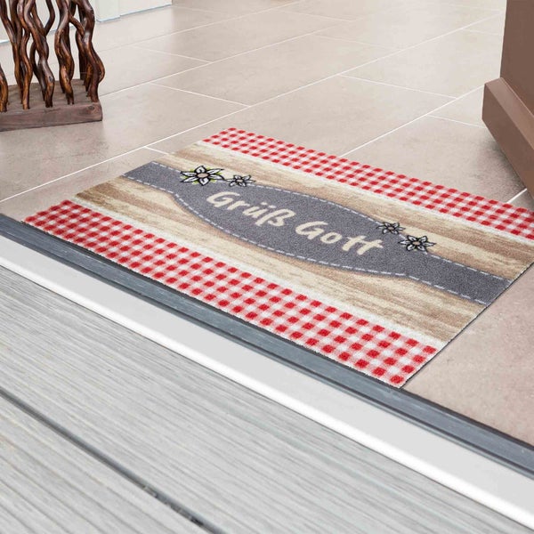 Fußmatte mit dem Schriftzug Grüß Gott und rot-weiß kariertem Muster