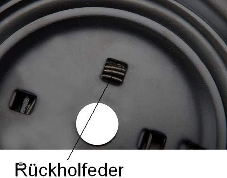 Detailansicht einer Rückholfeder an einem technischen Bauteil
