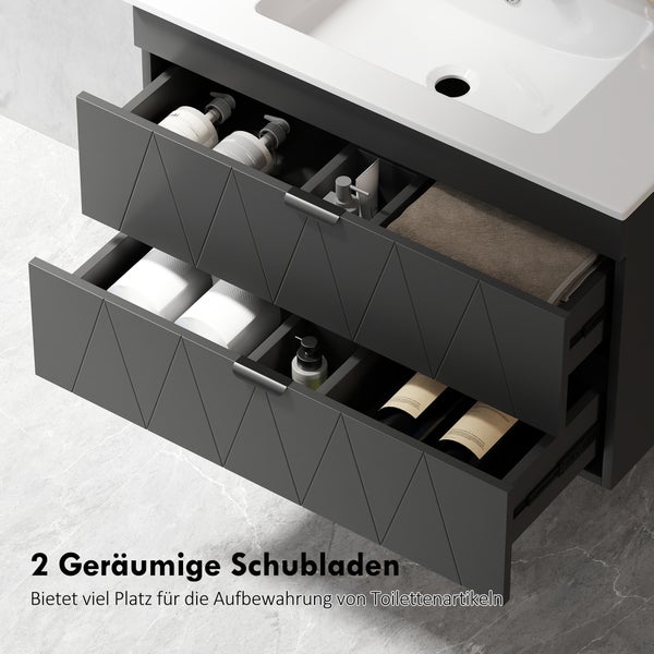 Dunkelgrauer Waschtischunterschrank mit zwei offenen Schubladen, Toilettenartikeln und dekorativem Rautenmuster auf der Front.