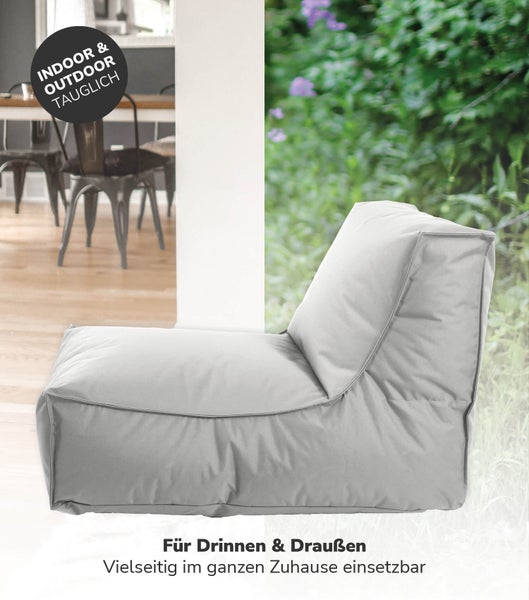 Dekorativer Raum mit Blumentapete, Holzkommode und rundem Spiegel