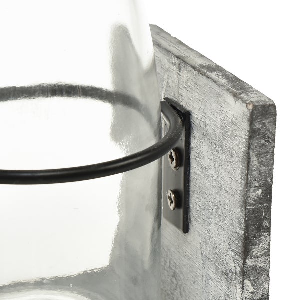 Detailaufnahme einer Wandhalterung aus Holz mit Glasvase und Metallring