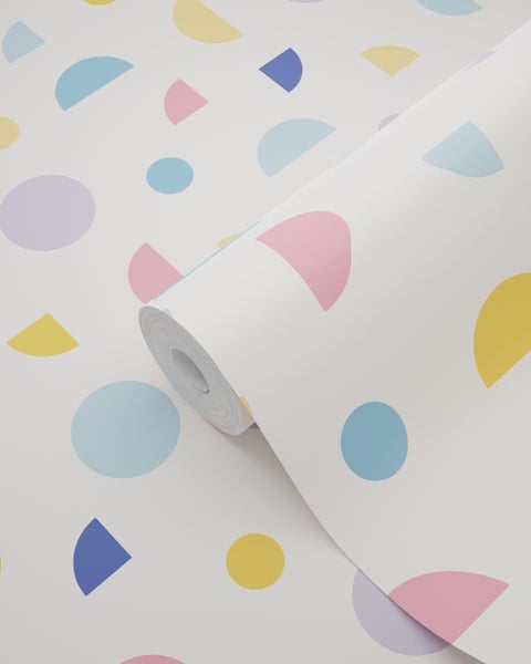 Eine Rolle Vliestapete mit geometrischem Muster aus bunten Kreisen und Halbkreisen auf hellem Grund.